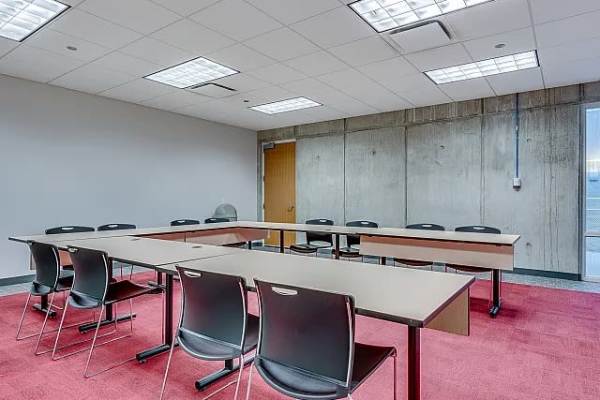 A spacious conference room equipped with a long table at The Flats at East West University in Chicago, Illinois