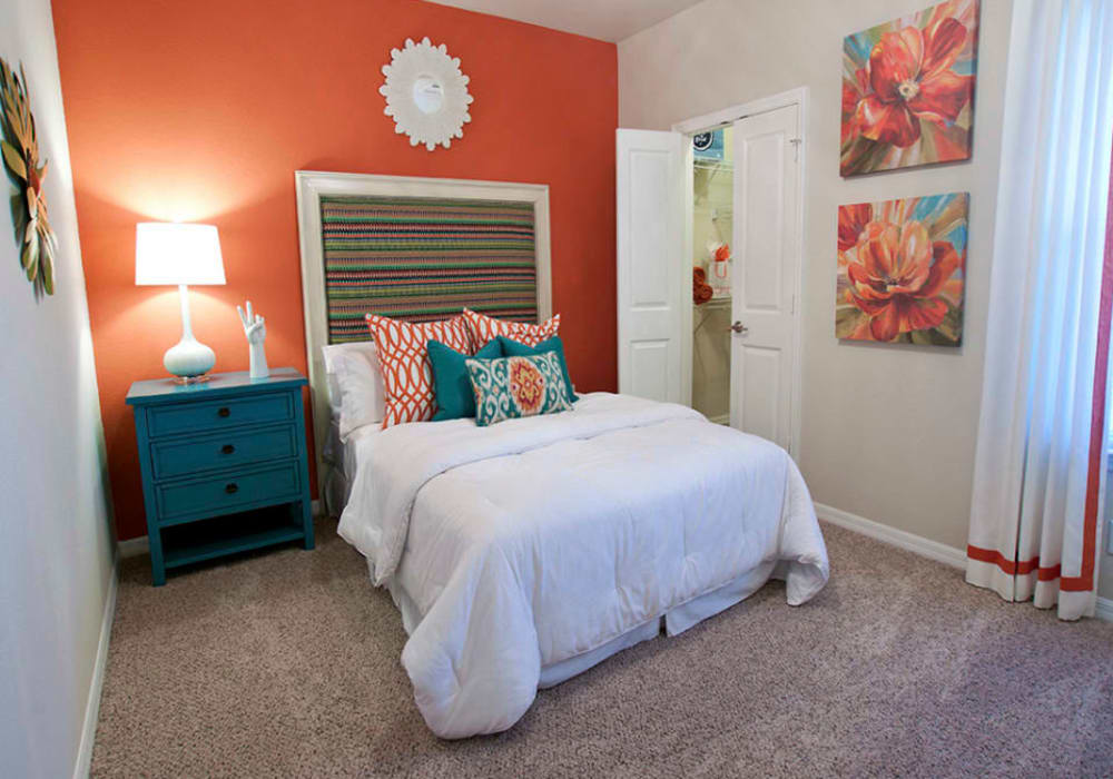 Well-decorated bedroom in a model home at Latitude at Mallard Creek in Charlotte, North Carolina