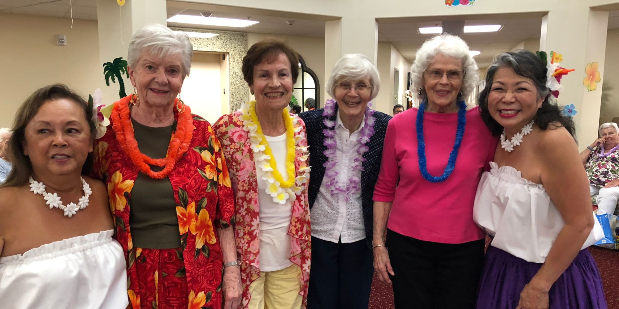 Residents dressed in a tropical theme at The Palms at La Quinta Assisted Living and Memory Care in La Quinta, California