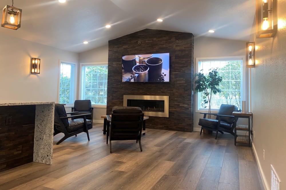 Modern community clubhouse with a large TV and a fire place at Autumn Chase in Bothell, Washington