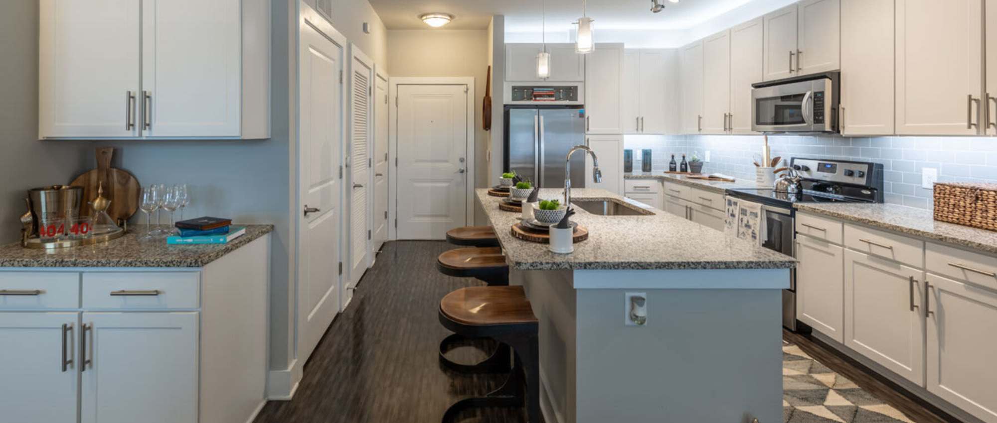 Kitchen with modern white cabinetry at Centra At North Druid Hills in Atlanta, Georgia