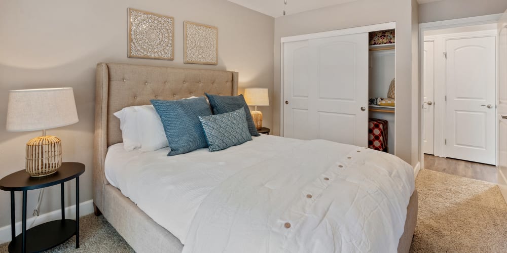 Spacious model bedroom with large closets and ensuite bathroom at Pinebrook Apartments in Fremont, California