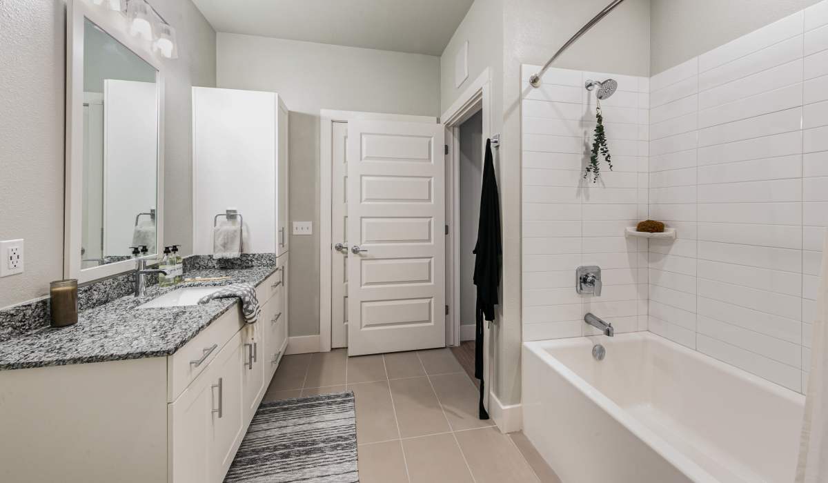 Modern bathroom with vanity light and bathtub at  The View at Belterra in Austin, Texas