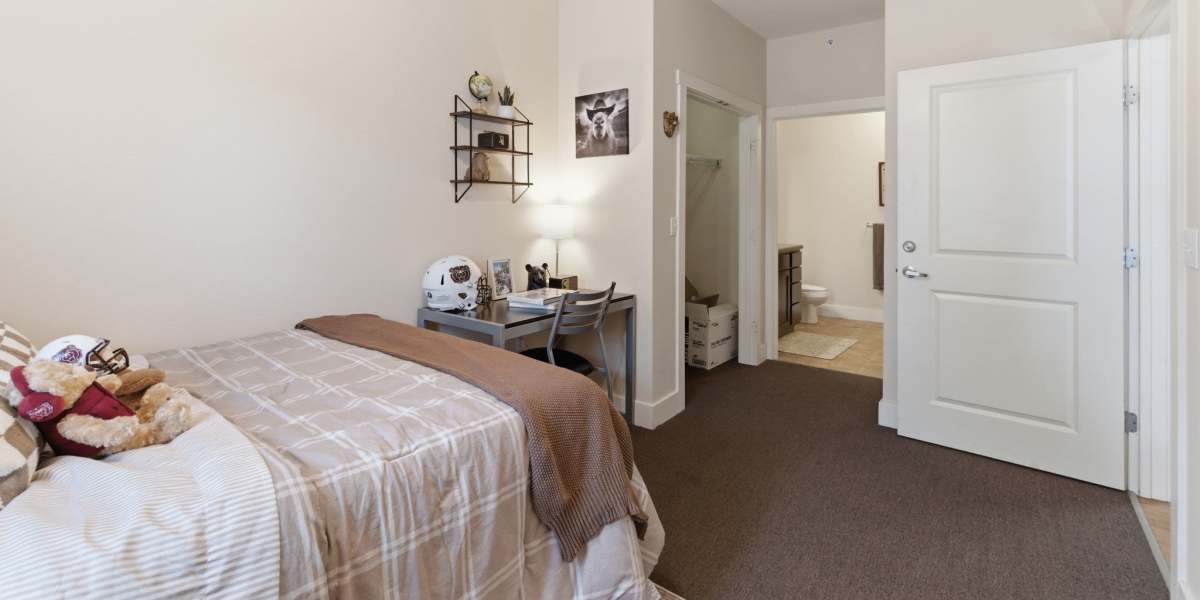 Cozy bedroom with desk and bathroom at Beacon Springfield in Springfield, Missouri