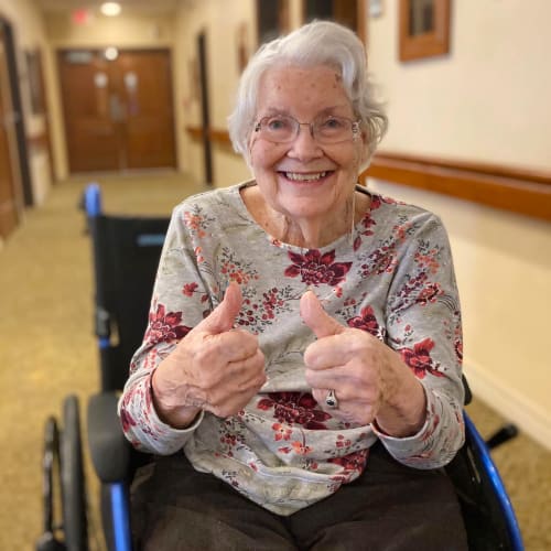 Happy resident giving two thumbs up at Oxford Glen Memory Care at Carrollton in Carrollton, Texas