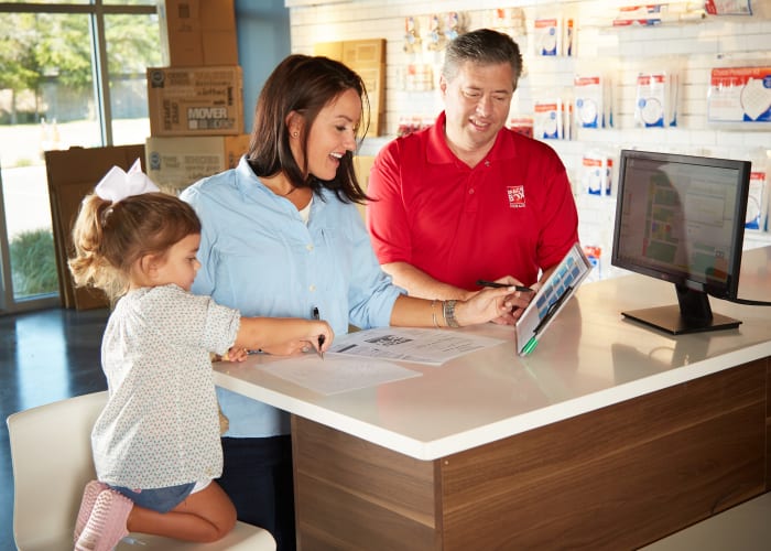 Friendly staff member assisting customer at Spacebox Storage Crestview in Crestview, Florida.