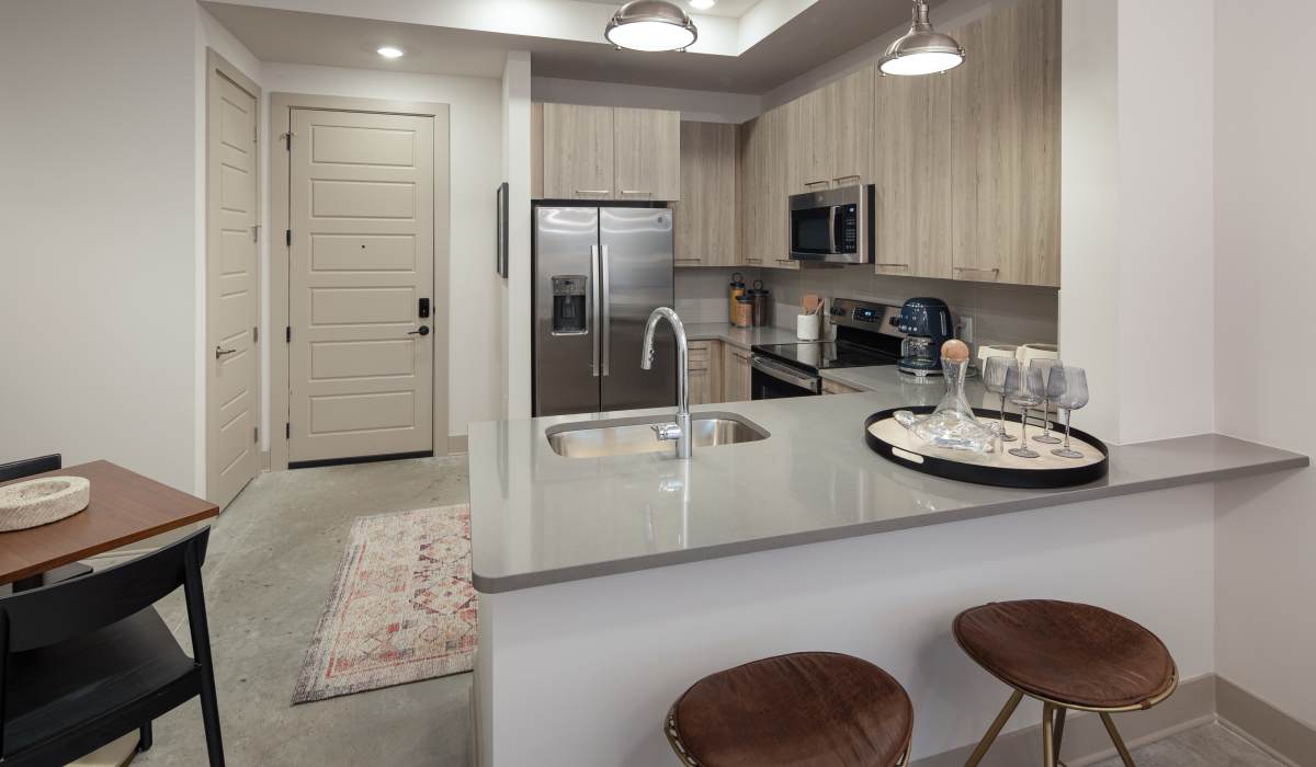 Apartment kitchen with stainless-steel appliances at Venable Durham Apartments in Durham, North Carolina