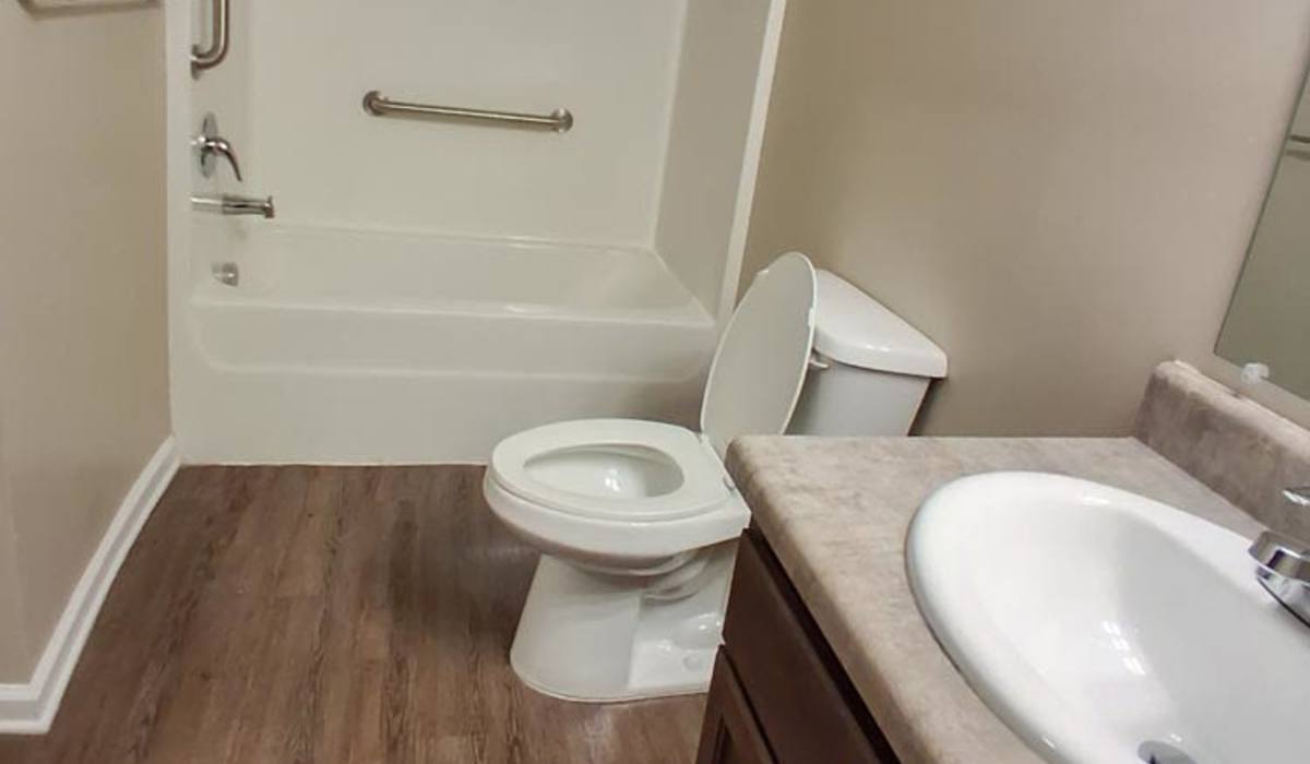 Bathroom with bathtub and commode at Adair Court in Atlanta, Georgia