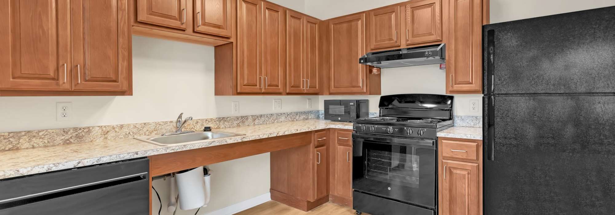 Kitchen with wood cabinets at Robinson Overlook in Columbia, Maryland