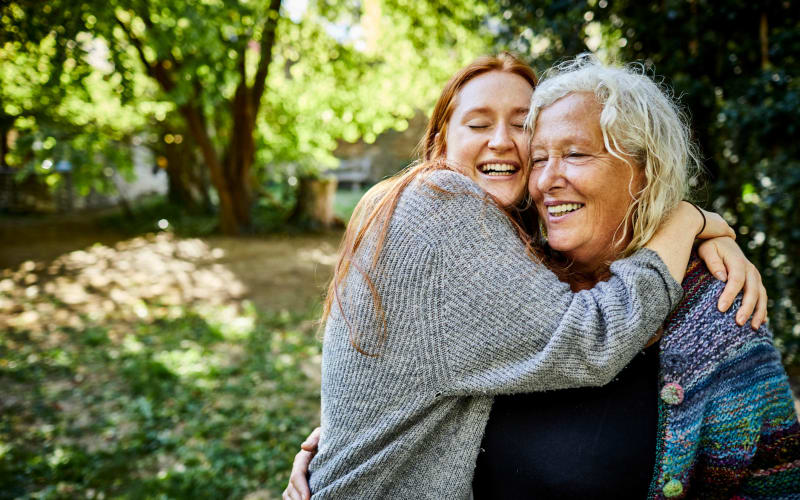 Happy resident with her daughter at Grand Villa of Palm Coast in Palm Coast, Florida