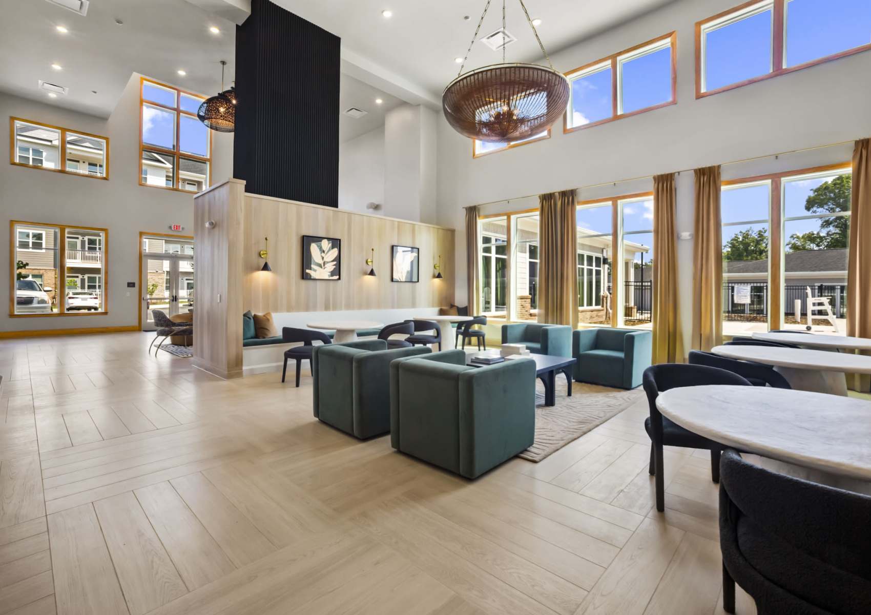 Modern apartment clubhouse featuring communal kitchen and seating areas at Canopy on Western in Waldorf, Maryland