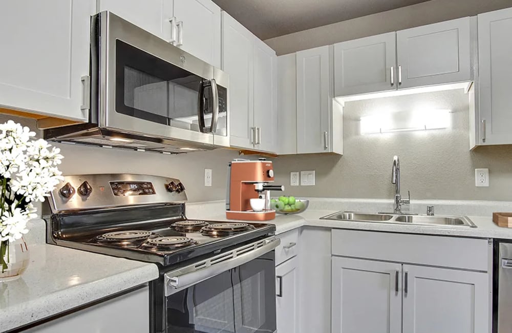 Modern kitchen with white cabinets at  The Aurora Apartments in Sparks, Nevada