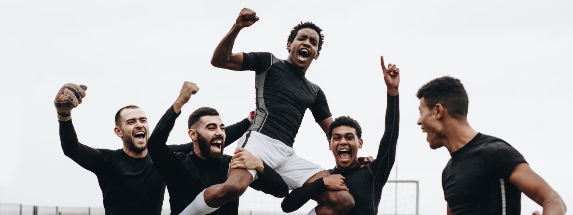 Soccer players raising a teammate on their shoulders after scoring the winning goal near 20 Hawley in Binghamton, New York