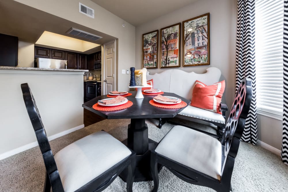 Dining room with large windows overlooking kitchen at Marquis at Stonegate in Fort Worth, Texas