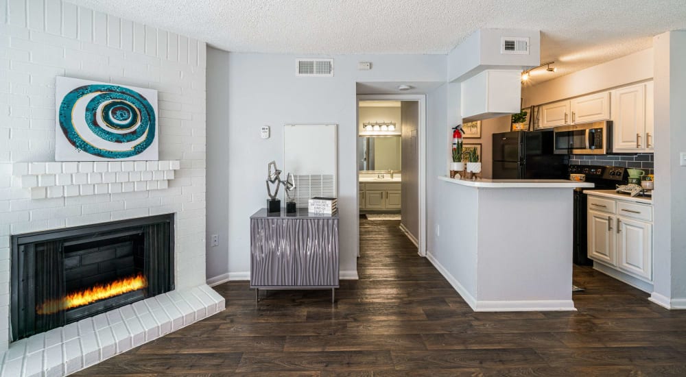 Resident living space with wood-style flooring at The Legacy at Clear Lake in Webster, Texas