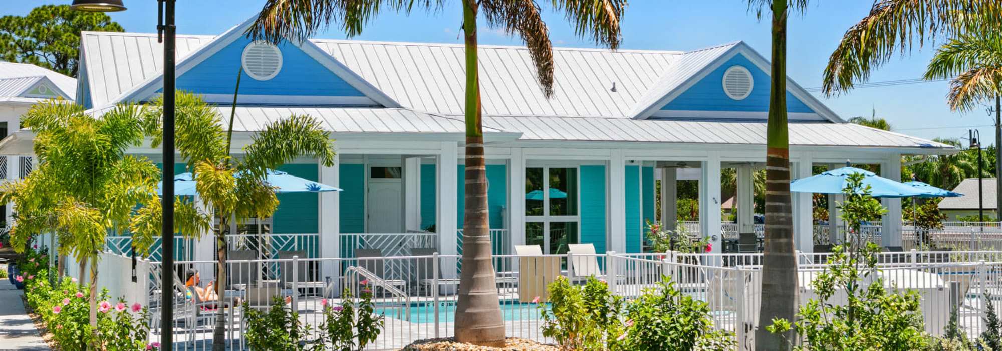 Charming outdoor retreat with lush landscaping and a sparkling water pool at  in Englewood, Florida. Lemon Bay Apartments in Englewood, Florida