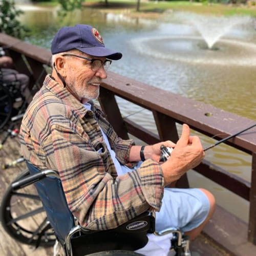 A resident smiling outside at Oxford Glen Memory Care at Owasso in Owasso, Oklahoma