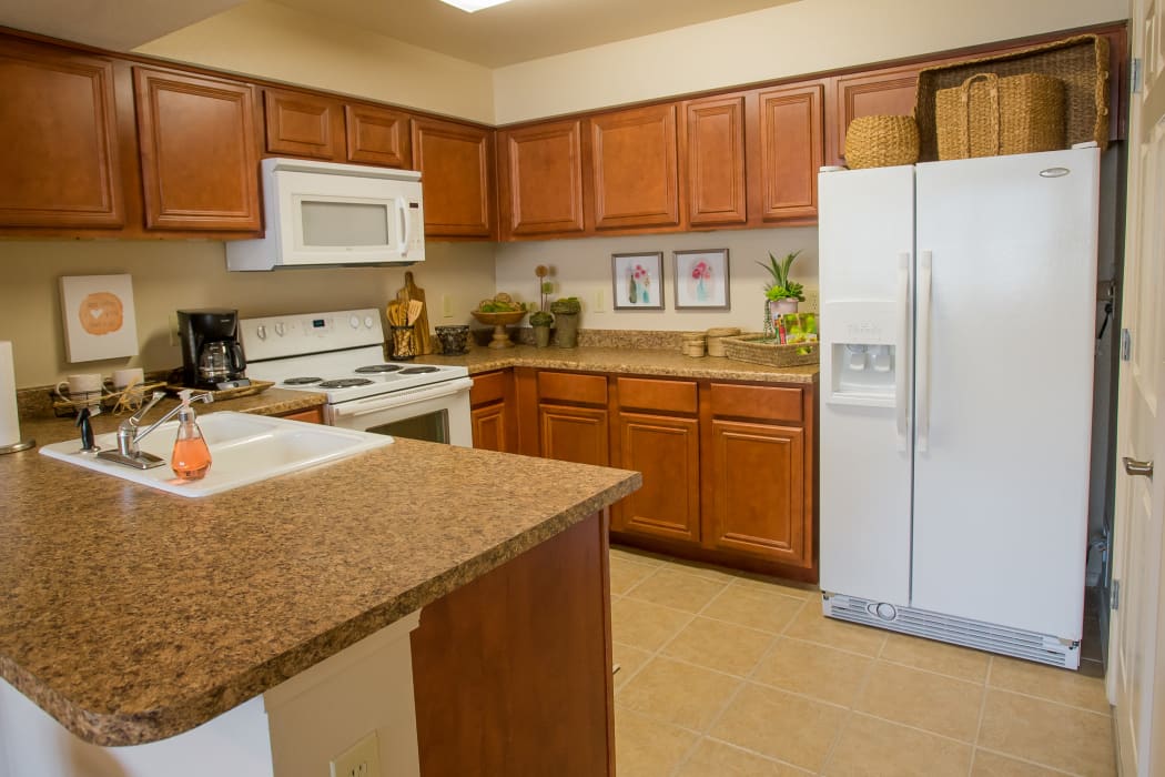 Kitchen with white appliances at Nickel Creek Apartments in Tulsa, Oklahoma