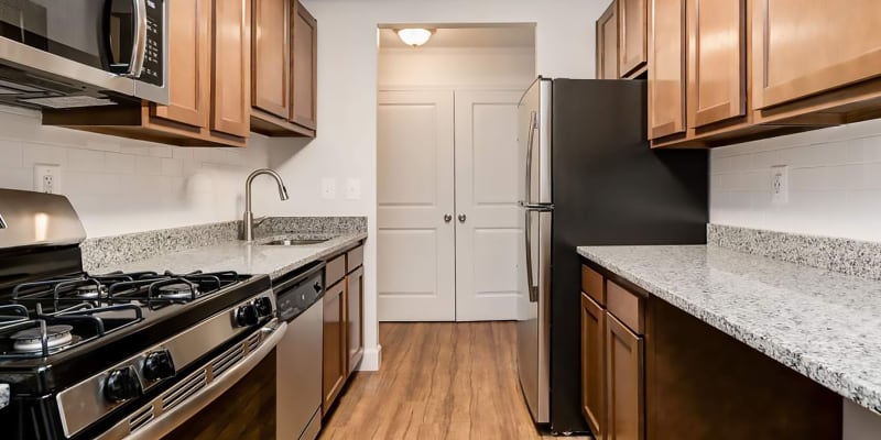 Model kitchen with stainless-steel appliances at Rolling Park Apartments in Windsor Mill, Maryland