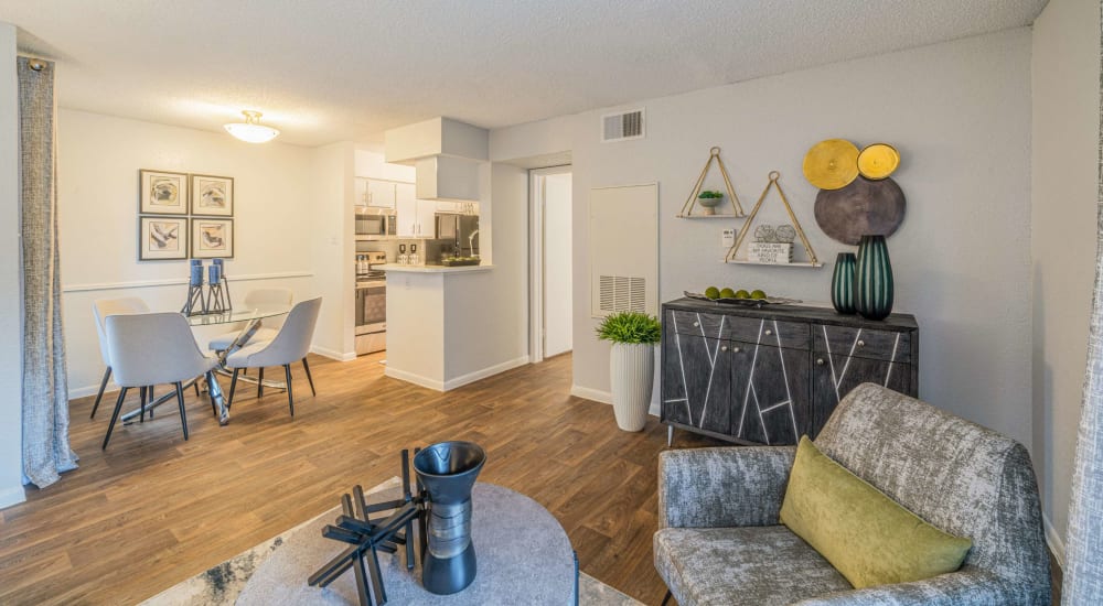 Modern open living space with wood-style flooring at The Parker at Ellington in Houston, Texas