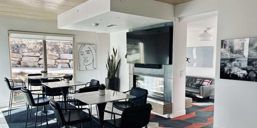 Room with tables and chairs for residents at Ascent 1791 in Park City, Utah