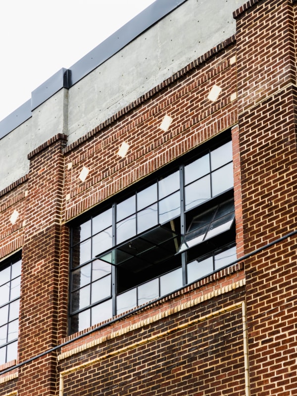 Brick building with open window at Braden Fellman Group in Atlanta, Georgia