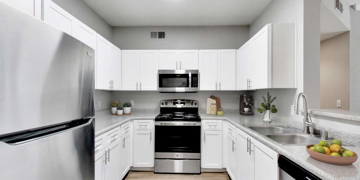 Beautiful renovated kitchen with white cabinetry at Natomas Park Apartments in Sacramento, California