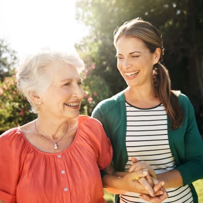 Resident walking outside with a caretaker at York Gardens in Edina, Minnesota