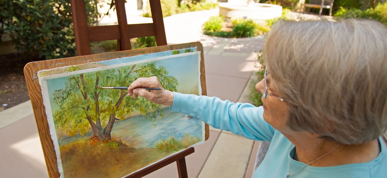 A resident painting at a Merrill Gardens community.