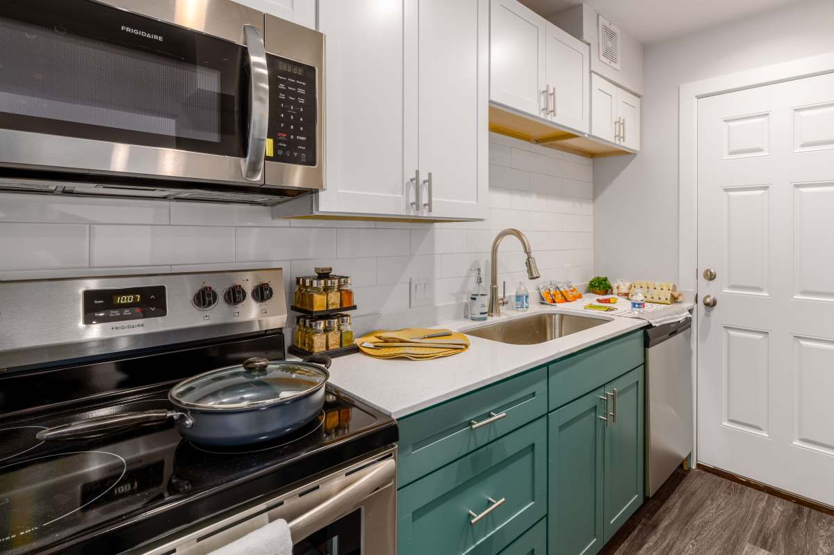 Charming modern kitchen with sleek stainless steel appliances and stylish cabinetry at Sangria Park in Austin, Texas.