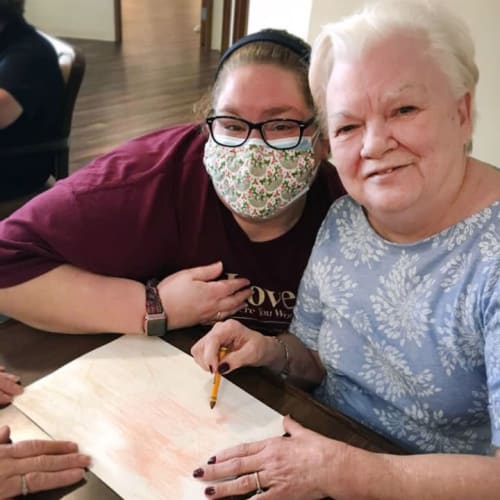 Resident coloring with crayons at The Oxford Grand Assisted Living & Memory Care in McKinney, Texas