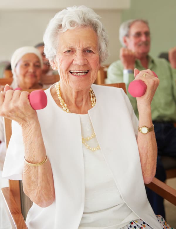 Woman exercising with weights at The Phoenix at Estero in Estero, Florida