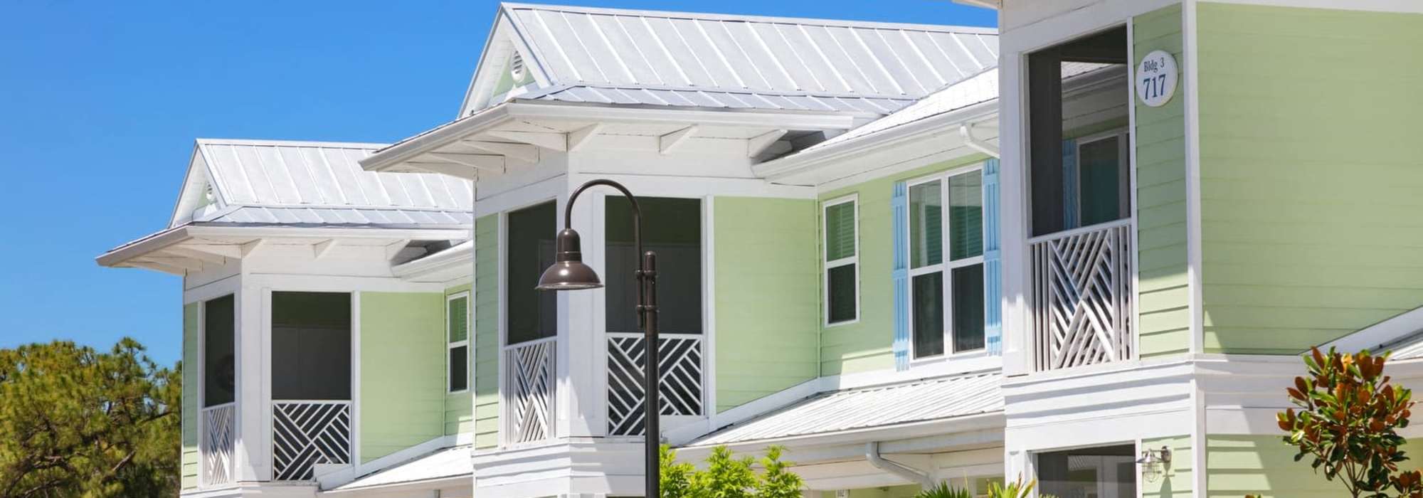 Charming townhomes offer modern aesthetics and inviting exteriors surrounded by lush landscaping at Lemon Bay Apartments in Englewood, Florida