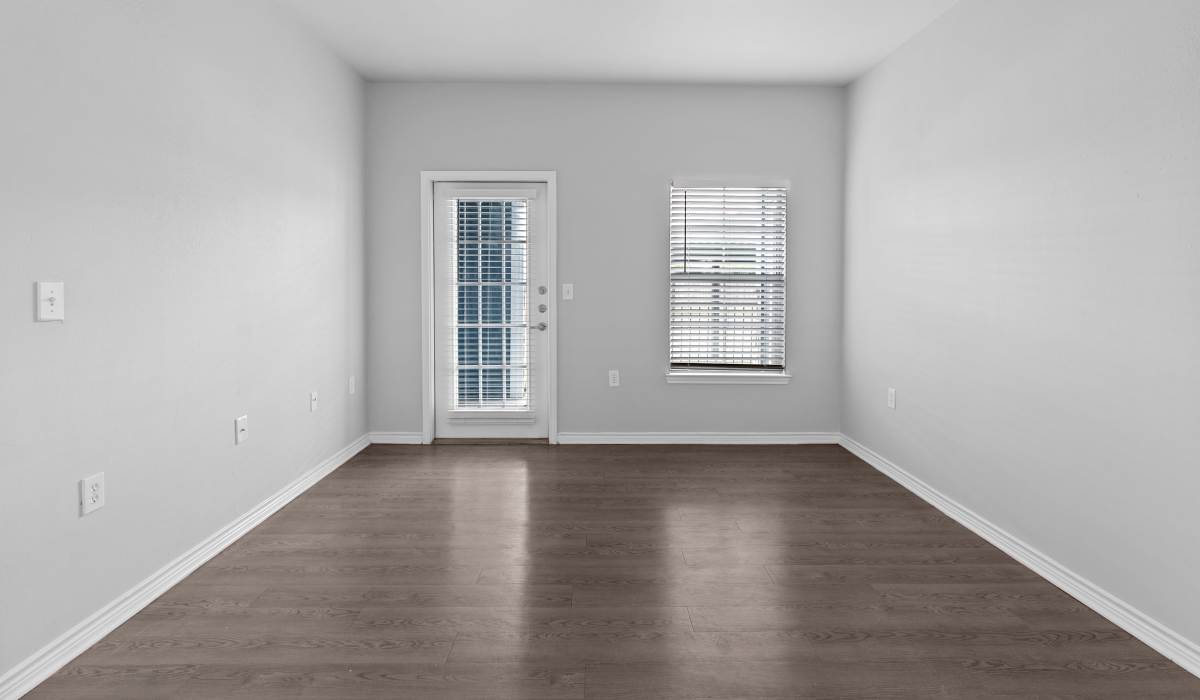 Unfurnished bedroom with windows and hard wood flooring at Stoneleigh Corpus Christi in Corpus Christi, Texas