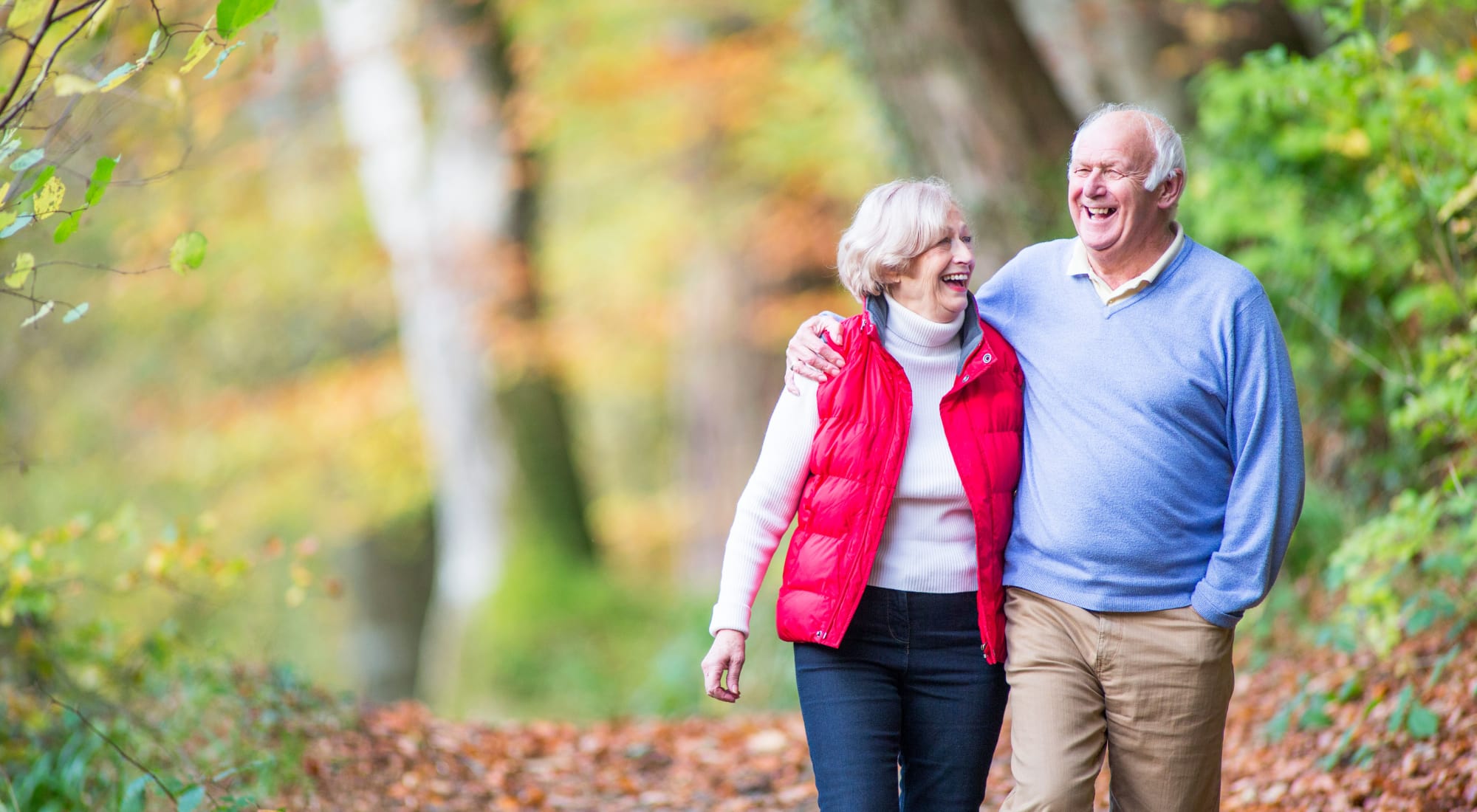 Senior living residents walking down a path near Maplewood Senior Living