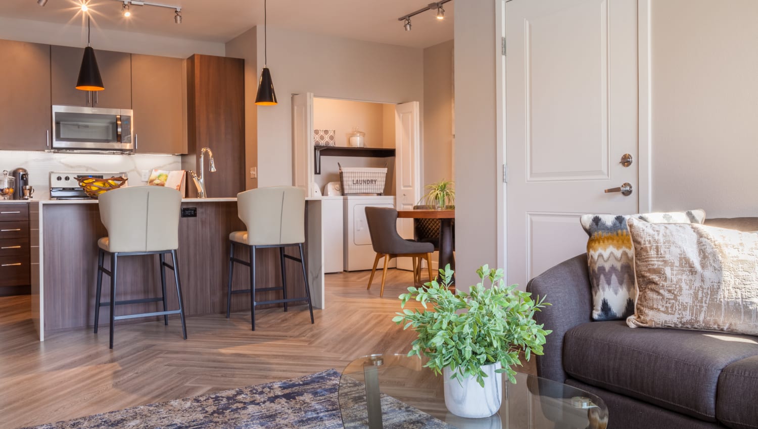 Spacious living room with view of kitchen at Olympus Alameda in Albuquerque, New Mexico