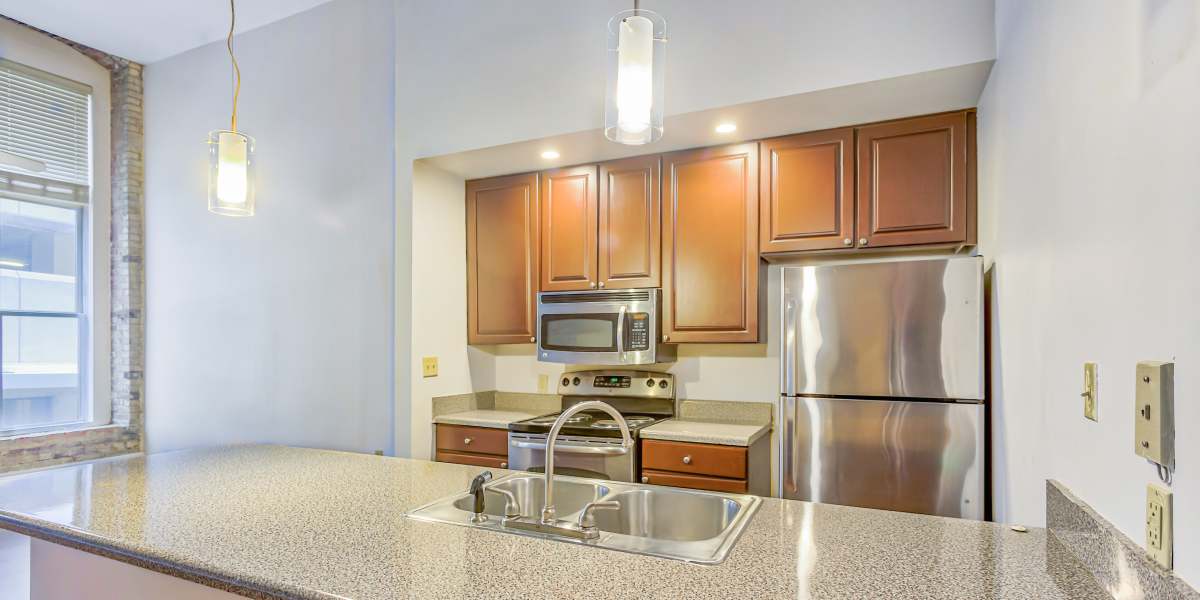 Apartment kitchen with pendant lights at The Washburn in Memphis, Tennessee