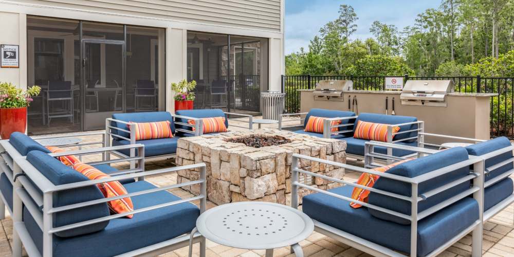 Outdoor firepit with comfy seating at Art Avenue Apartment Homes in Orlando, Florida