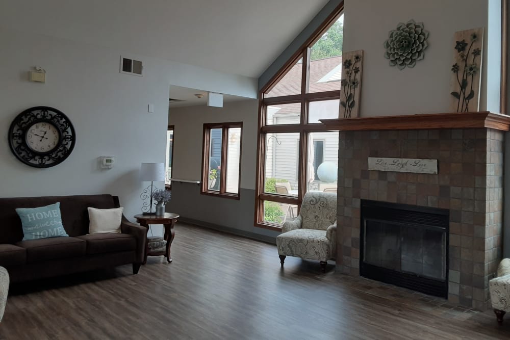 Comfortable resident sitting room with fireplace at The Atrium in Rockford, Illinois