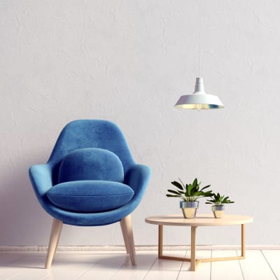 Modern chair and end table with plants in a model home at Sofi at 50 Forest in Stamford, Connecticut