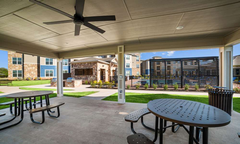 Seating area with lots of tables and ceiling fan at Brook Hollow in Wichita Falls, Texas