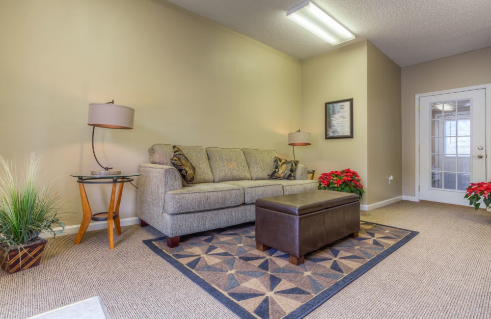 Living room with plank flooring in a model home at Highland Ridge Apartment Homes in High Point, North Carolina