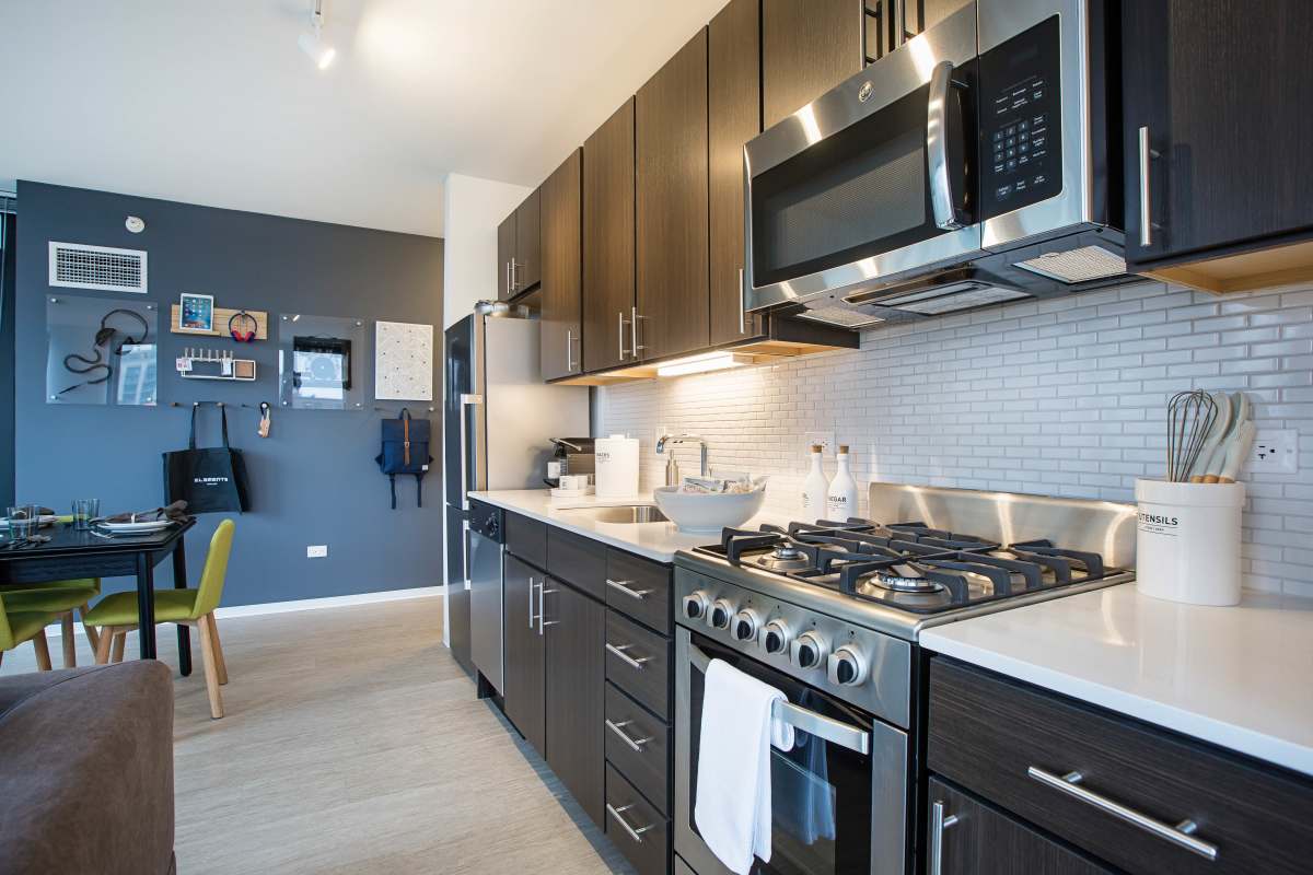 Kitchen with stainless-steel hardware and appliances at Exhibit On Superior in Chicago, Illinois