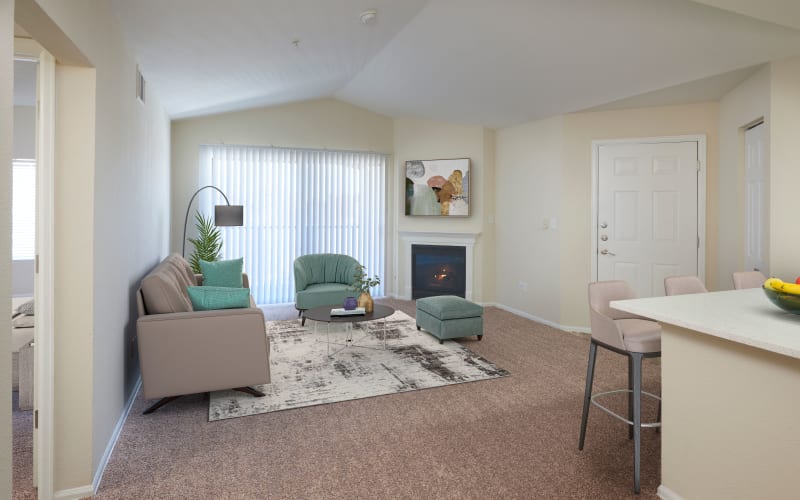 Living room with a private patio at The Crossings at Bear Creek Apartments in Lakewood, Colorado