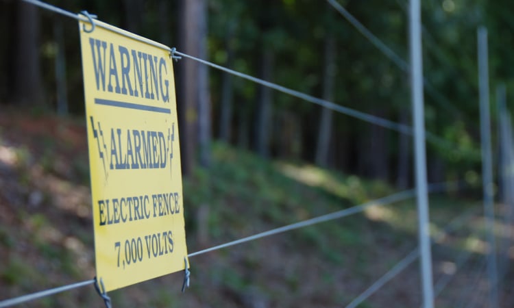 Warning electric fence banner at Atlantic Self Storage in Charlotte, North Carolina