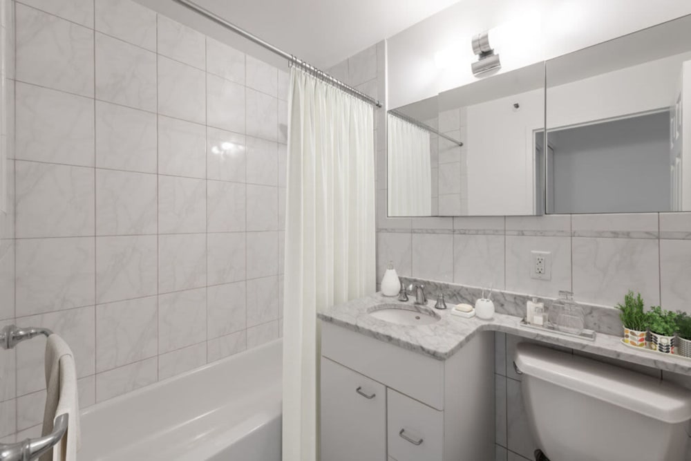 Model bathroom with tile shower at 28 Exeter at Newbury in Boston, Massachusetts