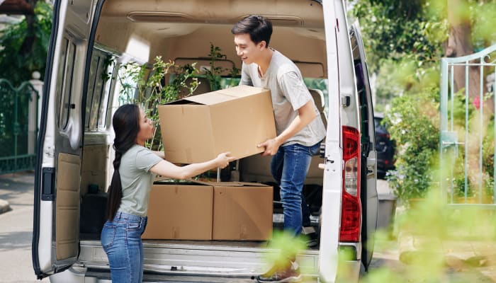 A couple unloading boxes from a van at their new home near STOR-N-LOCK Self Storage in Salt Lake City, Utah