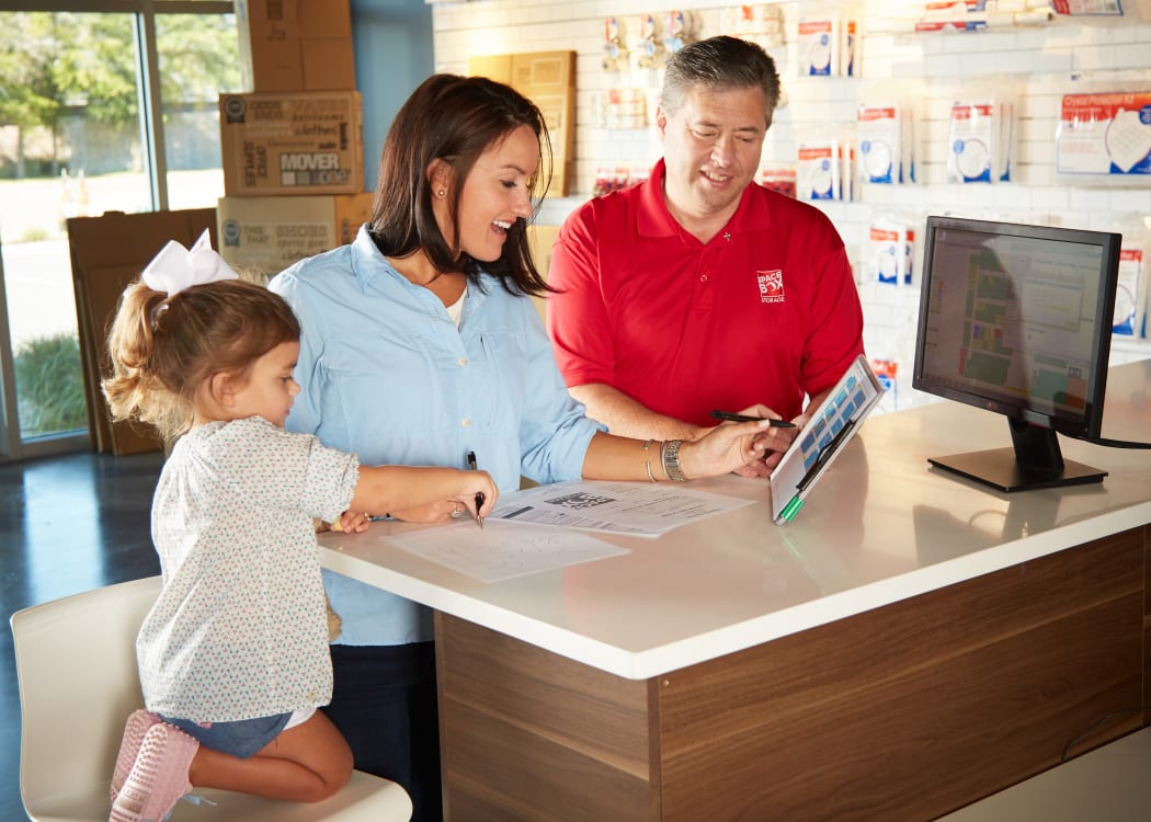 Friendly staff member assisting at front desk at Spacebox Storage Apopka in Apopka, Florida.