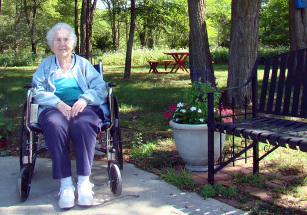 Resident enjoying the fresh air and flowers outside at Montello Care Center in Montello, Wisconsin