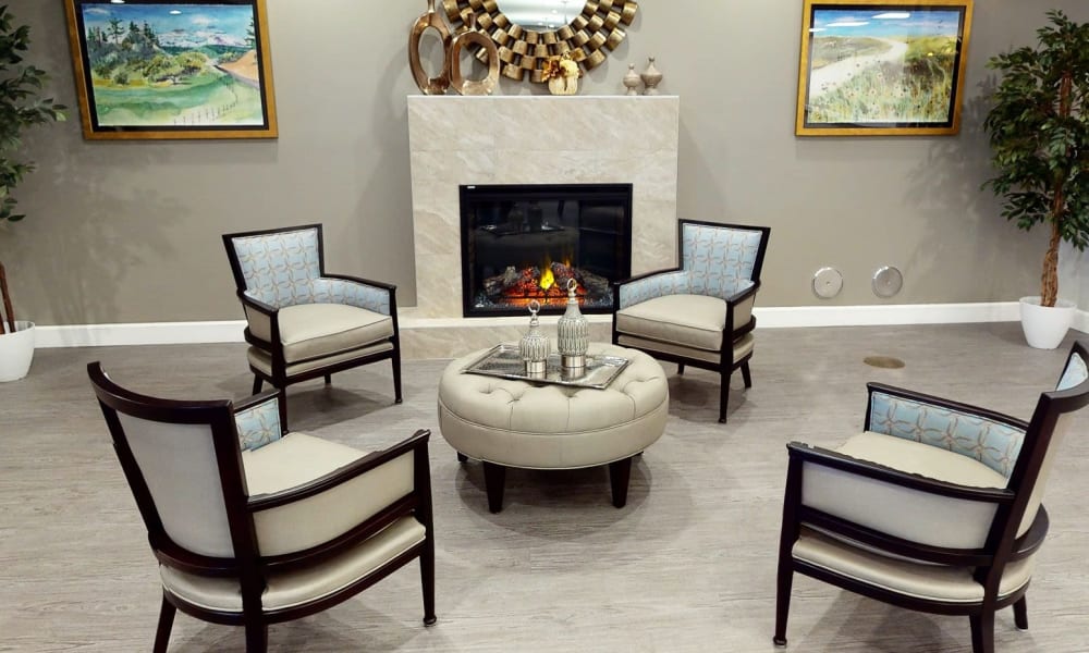 Four chairs near a fireplace at Keystone Place at Richland Creek in O'Fallon, Illinois